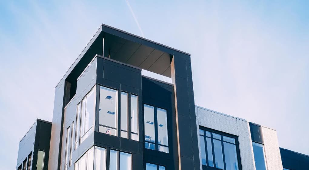 Modern corporate housing apartment building offering comfortable, extended stay accommodations for workforce travelers.